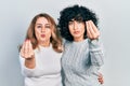 Middle east mother and daughter wearing casual clothes doing italian gesture with hand and fingers confident expression