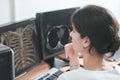 middle east woman doctor looking at monitor with chest bones computer tomography image. female young radiologist