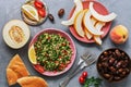 Middle Eastern and Arab food tabbouleh salad, pita, melon, peach and dates on a gray background. Top view, flat lay Royalty Free Stock Photo
