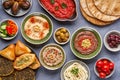 Middle eastern, arabic traditional breakfast with hummus, foul, mutabbal, makdous and zaatar. Top view