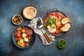 Middle Eastern breakfast or brunch with Shakshouka in pan, toasts, vegetables salad, hummus, olives Royalty Free Stock Photo