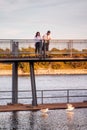 Middle eastern couple on the bridge watching the seagulls over the saint lawrence river