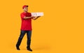 Middle Eastern Courier Holds Stack Of Pizzas Boxes, Yellow Background