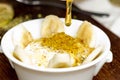 Middle eastern creamy dessert with nuts and honey / ashta w assal Royalty Free Stock Photo