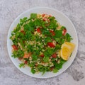 Middle Eastern cuisine. Vegetarian salad with bulgur, vegetables. Fresh bright arabic salad. Tabbouleh salad