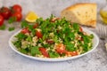 Middle Eastern cuisine. Vegetarian salad with bulgur, vegetables. Fresh bright arabic salad. Tabbouleh salad