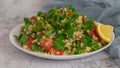 Middle Eastern cuisine. Vegetarian salad with bulgur, vegetables. Fresh bright arabic salad. Tabbouleh salad Royalty Free Stock Photo