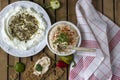 Middle Eastern dish - dense homemade labneh yoghurt with zatar in white dishes. Daylight.