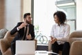 Middle eastern ethnicity businessman african businesswoman discuss deal in office Royalty Free Stock Photo