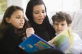 A Middle Eastern family reading a book together Royalty Free Stock Photo