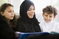 A Middle Eastern family reading a book together Royalty Free Stock Photo