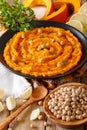 Middle Eastern food: pumpkin hummus with garlic, lemon and pepper closeup. vertical Royalty Free Stock Photo