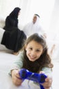 A Middle Eastern girl playing a video game Royalty Free Stock Photo