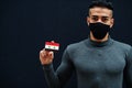 Middle eastern man in gray turtleneck and black face protect mask show Syria flag isolated background Royalty Free Stock Photo