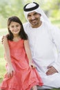 A Middle Eastern man and his daughter in a park Royalty Free Stock Photo