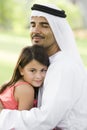 A Middle Eastern man and his daughter in a park Royalty Free Stock Photo