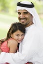 A Middle Eastern man and his daughter in a park Royalty Free Stock Photo