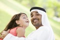 A Middle Eastern man and his daughter in a park Royalty Free Stock Photo