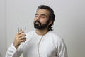 Middle Eastern Man Holding A Glass Of Water With Closed Eyes Enjoying The Taste