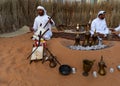 A Middle Eastern man singing and playing music | Arabic culture display - traditional cloth | Emirati Men | tourist attraction