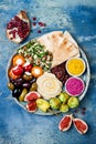 Middle Eastern meze platter with green falafel, pita, sun dried tomatoes, pumpkin, beet hummus, olives, stuffed peppers, tabbouleh Royalty Free Stock Photo