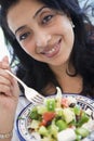 Middle Eastern woman holding a salad