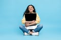 Middle Eastern Woman Hugging Laptop Computer Sitting On Blue Background Royalty Free Stock Photo