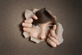 Middle eastern woman peeking from ripped white paper hole Royalty Free Stock Photo