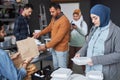Middle Eastern Woman Receiving Meal at Refugee Center Royalty Free Stock Photo