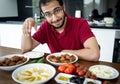 Middle Eastern young man sitting and eating traditional food