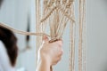 The middle knots of macrame. Girl ties knots