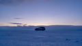 In the middle of nowhere. A car against the sky. A car journey through winter in Scandinavian country.