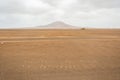 In The Middle of Nowhere written on the sand of Desert. Sal Island, Cape Verde. On background Pico do Fogo, Volcano Royalty Free Stock Photo