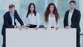 Professional business team holding a large blank white poster Royalty Free Stock Photo