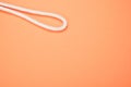 Middle part of the rope with two sides near each other on peach background