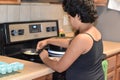 Middle sister cooking breakfast at the kitchen Royalty Free Stock Photo