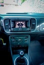 Middle view inside sport car cockpit, touchscreen navigation unit, air vents, dashboard controls