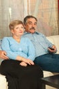 Middleaged couple watching tv home Royalty Free Stock Photo