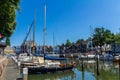 Stunning views over historic dutch yacht harbour with classic dutch historical houses and bike riders