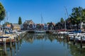 Stunning views over historic dutch yacht harbour with classic dutch historical houses and bike riders