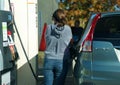 Woman customer pumping fuel at gas station