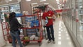 MIDDLETOWN, NY, UNITED STATES - May 29, 2020: Two Target Employees Stock Shelves with Inventory Cart while Wearing Masks
