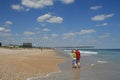 Middlle-aged couple walking barefoot on the beach Royalty Free Stock Photo