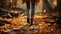 Midfoot lower section of woman walking through autumn leaves in forest. Concept of active lifestyle Royalty Free Stock Photo