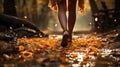 Midfoot lower section of woman walking through autumn leaves in forest. Concept of active lifestyle Royalty Free Stock Photo