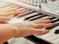 Midi keyboard or electronic piano and playing child hands. Royalty Free Stock Photo