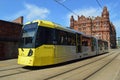 Midland Hotel Manchester with yellow metro link tram in foreground