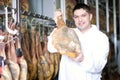 Midle aged butche with jamon at factory Royalty Free Stock Photo