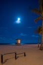 Midnight beach scene with full moon over ocean Royalty Free Stock Photo