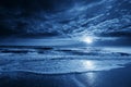 Midnight Blue Coastal Moonrise With Dramatic Sky and Rolling Waves Royalty Free Stock Photo